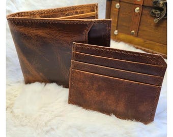 May include: Two brown leather wallets, one a standard bifold wallet and the other a slim card holder.