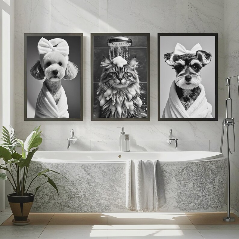 May include: Three framed black and white prints of pets in a bathroom setting. The prints feature a dog with a bow, a cat in the shower, and a dog in a robe. A bathtub, plant, and towels are in the foreground.