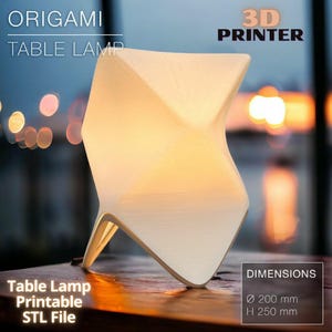May include: A white origami table lamp printed on a 3D printer. The lamp is shaped like a star and has a warm glow. The lamp is 8 inches in diameter and 10 inches tall. The text "ORIGAMI TABLE LAMP" and "3D PRINTER" is at the top of the image. The text "Table Lamp Printable STL File" is at the bottom left of the image. The text "DIMENSIONS Ø 200 mm H 250 mm" is at the bottom right of the image.