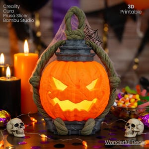May include: An illuminated orange pumpkin lantern with a carved face, a green rope handle, and a dark gray base. The lantern is surrounded by candles, skulls, and Halloween decorations. The text "3D Printable" is visible.
