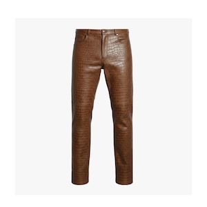 May include: Brown leather trousers with a crocodile texture. The trousers have a classic five-pocket design, a button and zip closure, and belt loops. The trousers are a medium brown colour.