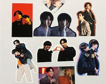 May include: A set of nine stickers featuring various images of two people. The stickers are printed on white paper and have a glossy finish. The images include a heart-shaped sticker with two people in it, a sticker with two people standing side-by-side, a sticker with two people hugging, and a sticker with two people making a heart shape with their hands.