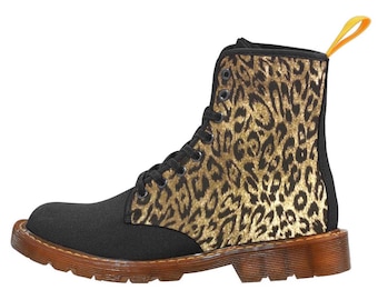 May include: Black canvas boots with a leopard print design. The boots have a brown rubber sole and a yellow pull tab.