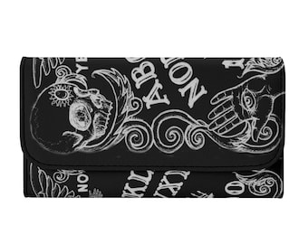 Tablero Ouija. Cartera negra de mujer plegable en tres partes.