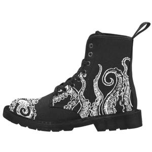 May include: Black combat boot with a white octopus tentacle design. The lace-up boot has a pull tab and a thick black sole. The tentacles are printed on the side and toe of the boot.
