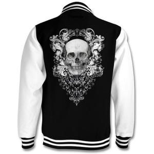 May include: A black and white varsity jacket with a white skull and floral design on the back. The jacket has white sleeves and black body with white stripes on the collar and cuffs.