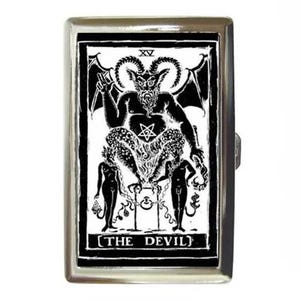 May include: A rectangular silver-toned metal case featuring a black and white graphic print of The Devil tarot card, marked with the Roman numeral XV at the top and the text THE DEVIL at the bottom, depicting a horned figure with wings.