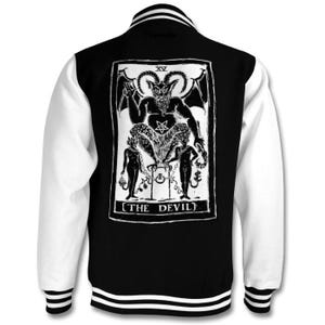May include: Black and white varsity jacket with a white and black striped collar and cuffs. The back of the jacket features a black and white illustration of the Devil card from a tarot deck. The text "THE DEVIL" is printed below the illustration.