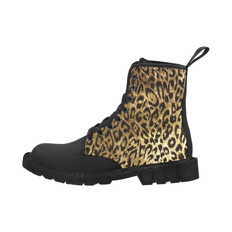 May include: Black canvas boots with a black and gold leopard print design. The boots have a lace-up closure and a thick, black rubber sole. The leopard print is by artist Shayne of the Dead.