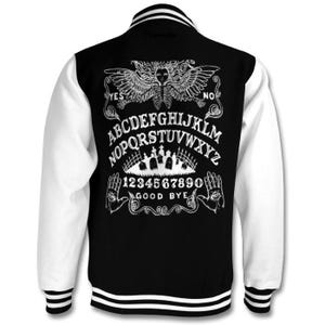 May include: Black and white varsity jacket with a white ouija board design on the back. The design includes the letters of the alphabet, numbers, and the words "yes", "no", and "good bye".