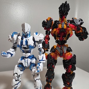 May include: Two articulated robot action figures. One is white and blue, the other is black, red, and yellow. The figures are posed with their arms and legs slightly bent, showcasing their detailed mechanical designs. They stand on a white surface.
