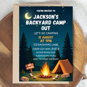 May include: A camping-themed invitation with a night sky background. The invitation reads "Jackson's Backyard Camp Out" with event details. A campfire, tent, and trees are illustrated. The RSVP information is also included.