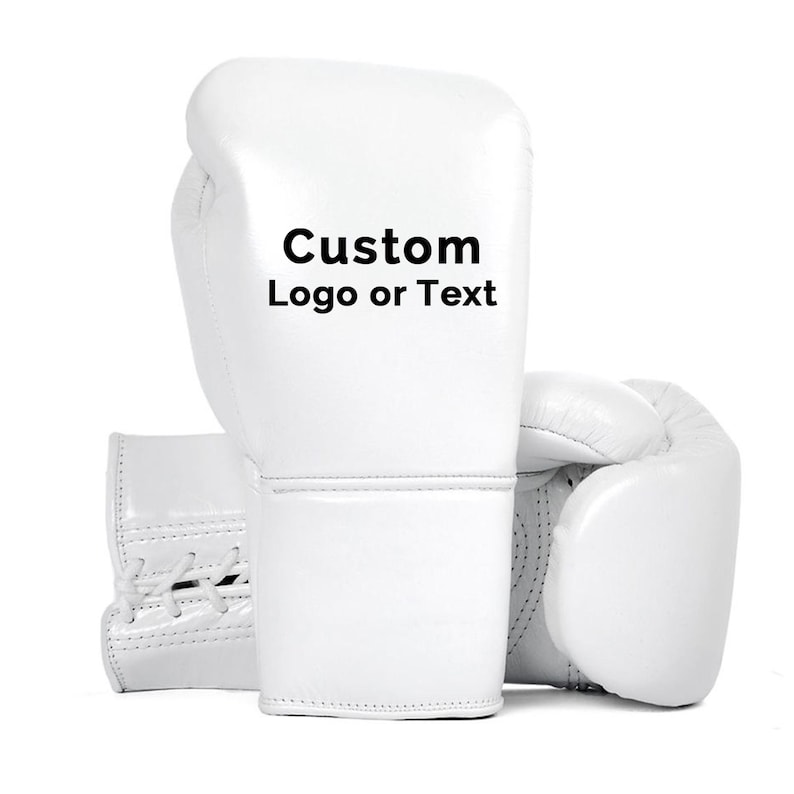 May include: Two white boxing gloves are displayed against a white background. The gloves are made of a smooth material and feature the text "Custom Logo or Text" on the front. The gloves are designed for boxing or other combat sports.
