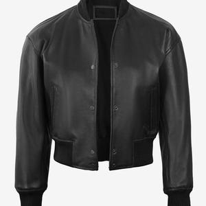 May include: A black leather bomber jacket with a ribbed collar, cuffs, and hem. The jacket has a snap-button closure and two front pockets. The jacket is a classic style, suitable for various occasions.