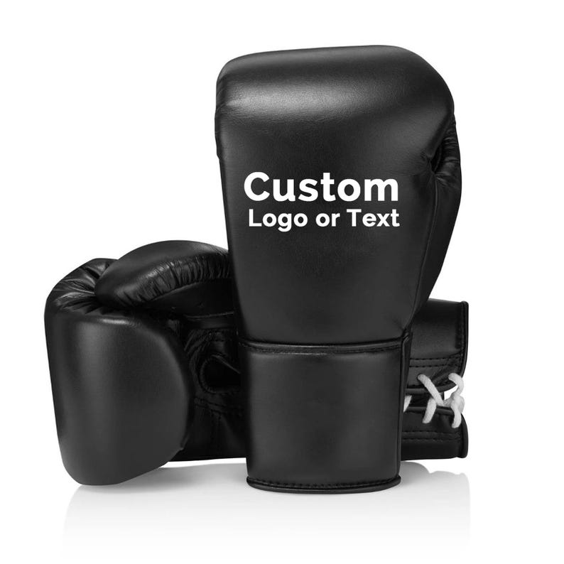May include: Black boxing gloves with white laces and the text "Custom Logo or Text" in white. The gloves are made of a smooth material and are designed for boxing or other combat sports.
