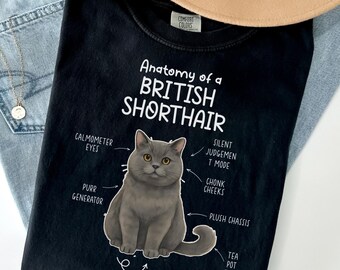 May include: Black t-shirt with a graphic of a British Shorthair cat and the text "Anatomy of a British Shorthair." The graphic labels the cat's features, including "Calmometer Eyes" and "Chonk Cheeks."