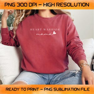 May include: A red sweatshirt with the text "HEART WARRIOR mama" and a small heart graphic printed on the front.