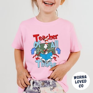 Teacher of All Things Dr Seuss Shirt, Reading Day Toddler T-Shirt, Read Across Adult Sweatshirt, Reading Week Bodysuit, Seuss Coquette Gifts