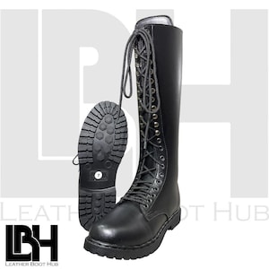 May include: Black leather knee-high boots with a lace-up design and a rugged sole. The boots have a round toe and a sturdy heel. The sole of one boot is visible, showing the size 7. The boots are from Leather Boot Hub.