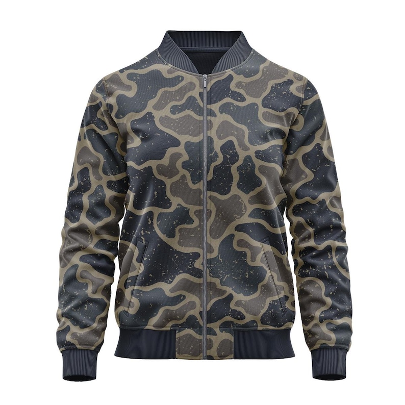 May include: A bomber jacket with a camouflage pattern in shades of gray, brown, and black. The jacket has a full zipper, two front pockets, and ribbed cuffs and hem. The fabric has a speckled texture.