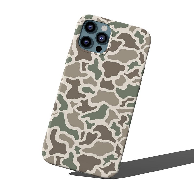 May include: A phone case with a camouflage pattern in shades of green, brown, and beige. The case has a glossy finish and a camera cutout. The phone case is designed to protect the phone from scratches and damage.