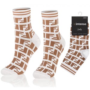 May include: A pair of white socks with a brown geometric pattern. The socks have a brown stripe at the top and the pattern is made up of the letter "F". The socks are on a white background. The image also includes a packaging label with the text "intenso Lady Luxury Cotton Socks 35-37".