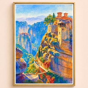 May include: Watercolor painting of a monastery perched atop a rocky cliff, framed in a gold border. The artwork depicts a vibrant landscape with blue skies, mountains, and lush greenery. The buildings have red tile roofs and stone walls.