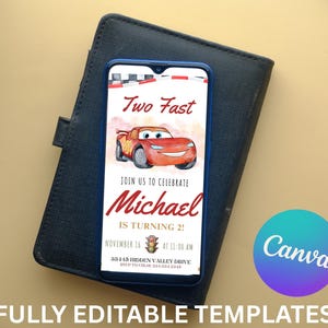K&ouml;nnte beinhalten: Ein Smartphone zeigt eine Geburtstagseinladung mit einer roten Rennwagen-Grafik und dem Text "Two Fast". Die Einladung ist f&uuml;r Michaels 2. Geburtstag, mit Datum und Uhrzeit. Das Telefon liegt auf einer schwarzen, lederartigen Oberfl&auml;che.