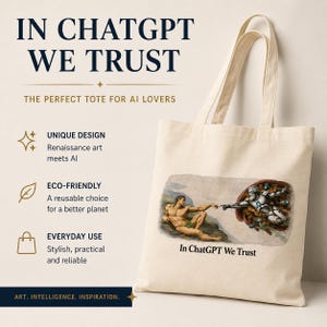 May include: A beige canvas tote bag featuring a printed graphic of a human hand reaching towards a robotic hand, inspired by The Creation of Adam, with the text In ChatGPT We Trust printed below the image in a dark serif font.