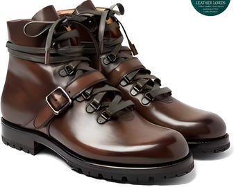 May include: A pair of brown leather boots with dark gray laces and straps. The boots have a buckle closure and a black sole. The Leather Lords logo is in the upper right corner.
