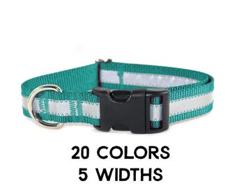 May include: A teal pet collar featuring a reflective silver strip running along the center, a black plastic side-release buckle, and a silver metal D-ring. The text 20 COLORS 5 WIDTHS is printed in black below the collar on a white background.