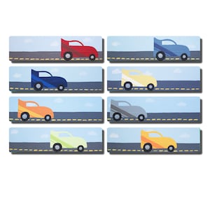 May include: Eight colorful race cars on a gray road with a blue sky and white clouds in the background. Each car has a different color and design.