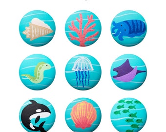 May include: Nine painted ocean-themed round stones with blue water and white waves. The stones feature images of a conch shell, coral, cuttlefish, eel, jellyfish, manta ray, orca, scallop shell, and a school of fish.
