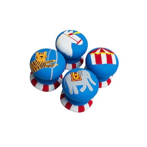 May include: Four blue and red painted wooden knobs with circus animal and tent designs. The knobs feature a tiger, an elephant, a horse, and a tent.