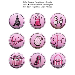 May include: Nine pink and white polka dot circles with various images, including the Eiffel Tower, a party dress, a poodle, the word "Paris", a perfume bottle, the letters "SFC", a hat box, a high heel shoe, and a purse.