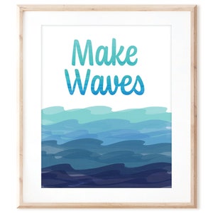 May include: A framed print with a blue and green watercolor design of ocean waves. The text "Make Waves" is written in a blue and green font.