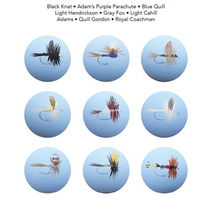 May include: Nine fishing flies, each on a light blue circular background. The flies are hand-painted with detailed wings and bodies in various colors, including black, purple, brown, and yellow. Text at the top lists the fly names: Black Knat, Adam's Purple Parachute, Blue Quill, etc.