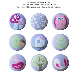 May include: Nine painted wooden circles with various nature-themed designs, including mushrooms, vines, an owl, an oak leaf and acorn, a birdhouse, a leaf, two birds, a flowering tree, and a bird with tail feathers.