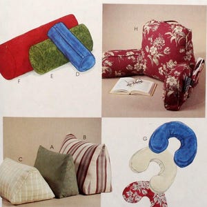 May include: A McCall's Home Decorating pattern featuring various pillow designs. The image showcases bolster pillows in red, green, and blue, along with wedge and decorative pillows. The pattern includes a floral print pillow and a unique, curved design.