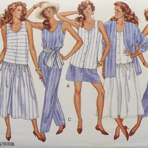 May include: A vintage Butterick sewing pattern featuring illustrations of women's clothing designs. The designs include striped dresses, jumpsuits, and separates in blue and white. The pattern is labeled "Fast & Easy."