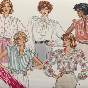 May include: A vintage Butterick Classics sewing pattern featuring illustrations of blouses with various designs, including polka dots, stripes, and floral prints. The pattern includes sizes 12-14-16 and the text "YES! IT'S EASY! OUI! C'EST FACILE!"