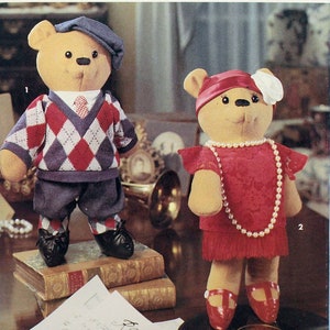 May include: A Simplicity Crafts sewing pattern for making two teddy bears. The pattern is for one size and includes instructions for making a teddy bear wearing a red dress and a teddy bear wearing a blue sweater and pants. The pattern is labeled "8265" and "Simplicity Crafts".