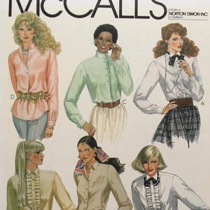 May include: A McCall's sewing pattern envelope for Liz Claiborne blouses, numbered 7751, featuring illustrations of six different long-sleeved blouse styles with various collar, ruffle, and bow details, designed for a 32.5 inch bust size.