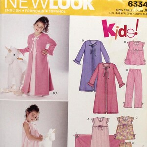 May include: New Look sewing pattern 6334 for children's sleepwear. The envelope displays illustrations and photographs of robes, nightgowns, tops, pants, and shorts in various colors and patterns, including pink, purple, and floral prints, with size range 3-8.