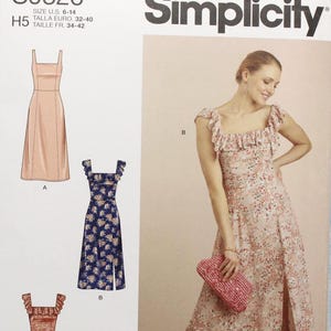 May include: Simplicity sewing pattern S9326 featuring three dress designs. The pattern includes sizes 6-14. The main image shows a woman wearing a floral print dress with a slit. The pattern is designed and printed in the USA.
