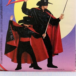 May include: A sewing pattern for a Zorro costume. The pattern includes instructions for making a black shirt, pants, mask, and red cape. The pattern is for sizes 5 and 6. The pattern is from McCall's Costumes and is titled "Zorro...the legend continues."
