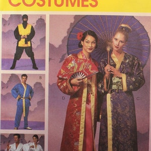 May include: A McCall's Costumes sewing pattern envelope, number 2940, featuring illustrations of various outfits including a ninja costume, a blue robe, white martial arts uniforms, and two long, patterned robes with a purple umbrella and fan.