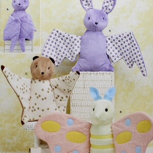 May include: Simplicity sewing pattern featuring stuffed animal designs. The pattern includes instructions for creating a purple bat, a brown bear, and a butterfly. The text "easy-to-sew" is visible. The pattern is designed and printed in the USA.