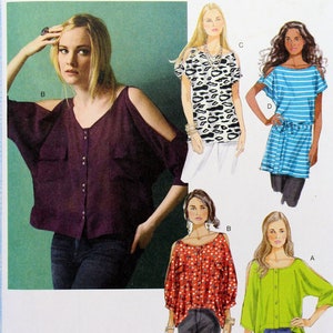 May include: A sewing pattern for four different tops with cold shoulder details. The tops are shown in various colors and patterns, including a burgundy top, a black and white animal print top, a blue and white striped top, a red polka dot top, and a green top. The pattern is from Butterick and is labeled B5889.
