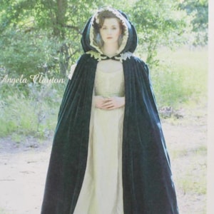 May include: McCall's costume pattern featuring a woman in a dark green hooded cloak and cream-colored dress. The pattern includes sizes XSM-XLG. The cover has the text "McCall's Costumes" and "Angela Clayton".